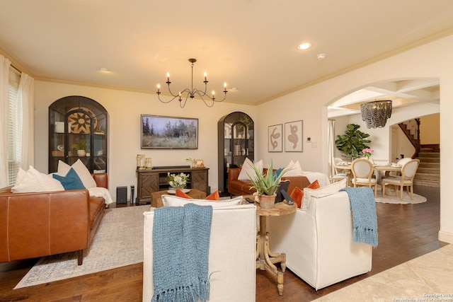 living room featuring dark hardwood / wood-style flooring, a notable chandelier, and ornamental molding