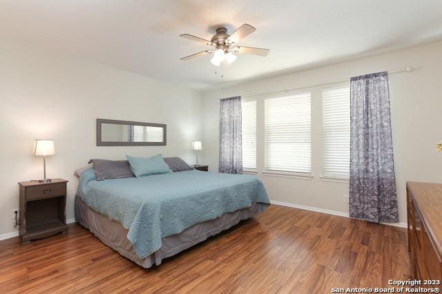 bedroom with ceiling fan and hardwood / wood-style floors