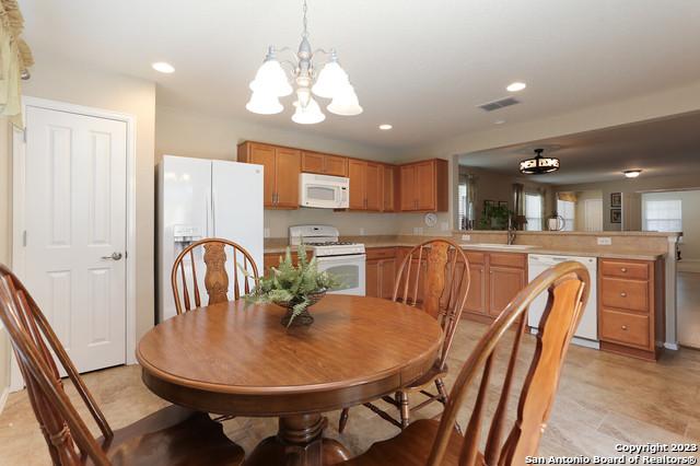 dining room featuring sink and a notable chandelier