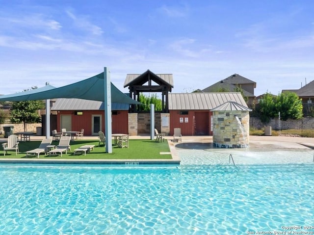 view of pool with an outbuilding and a patio