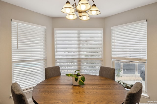 dining space featuring a healthy amount of sunlight and a notable chandelier