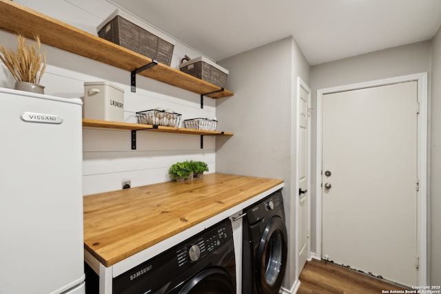 laundry room with dark wood-type flooring and washer and clothes dryer