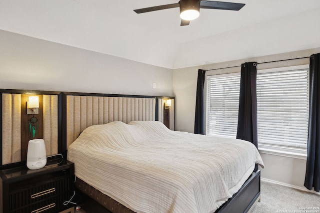 bedroom featuring ceiling fan, lofted ceiling, and light carpet