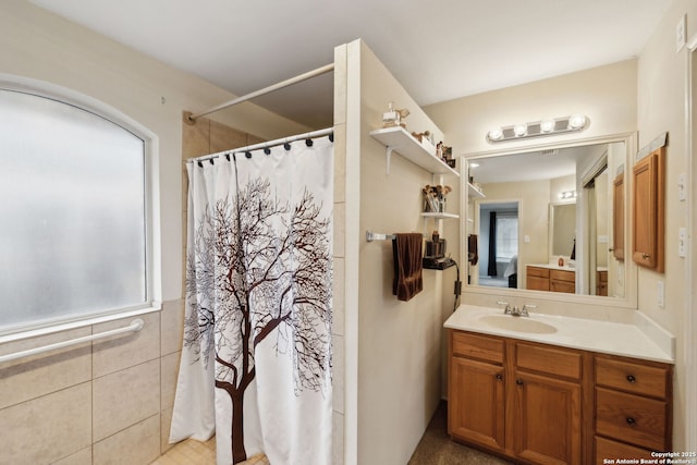 bathroom featuring vanity, curtained shower, and tile walls