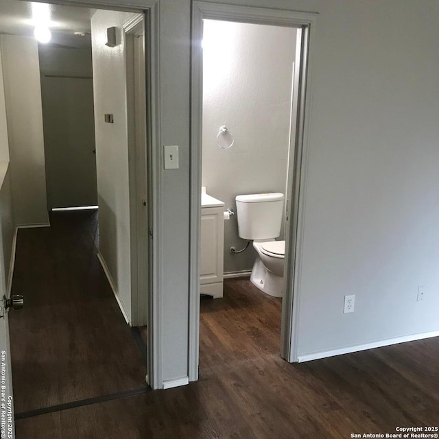 hallway with dark hardwood / wood-style floors