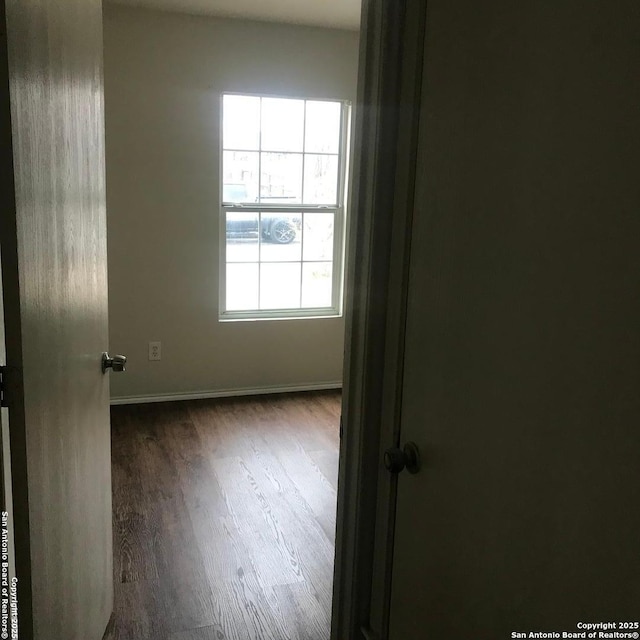 unfurnished room with dark hardwood / wood-style floors