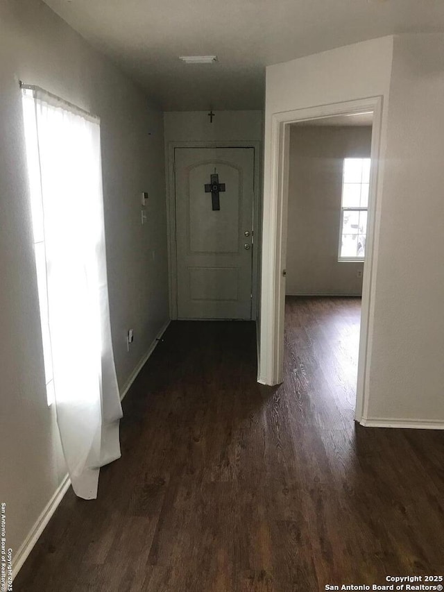 hallway with dark wood-type flooring