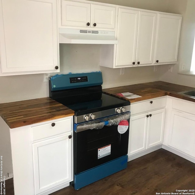 kitchen with white cabinetry, wood counters, dark hardwood / wood-style floors, and stainless steel electric range