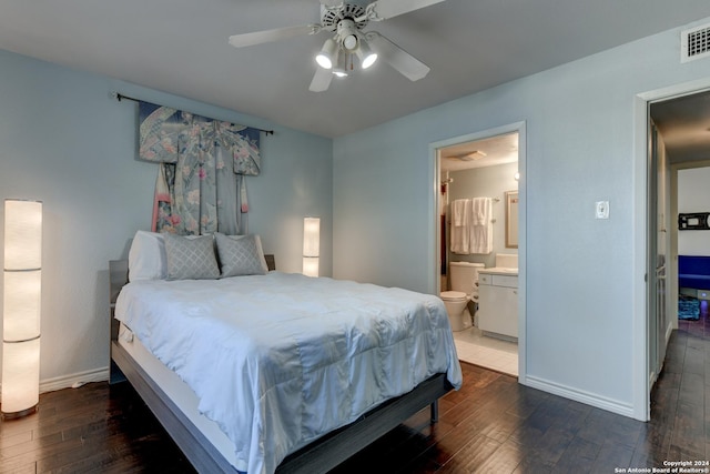 bedroom featuring ceiling fan, ensuite bath, and dark hardwood / wood-style floors