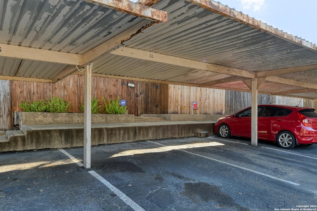 view of parking / parking lot featuring a carport