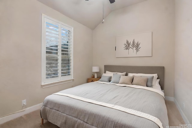 bedroom with vaulted ceiling, carpet floors, and ceiling fan