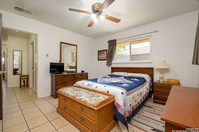 tiled bedroom featuring ceiling fan