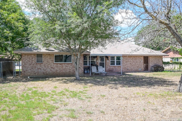 rear view of house with a patio area and a lawn