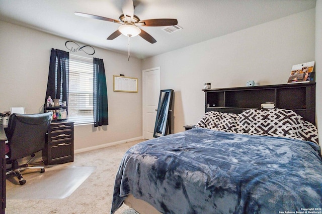 bedroom with ceiling fan and light carpet