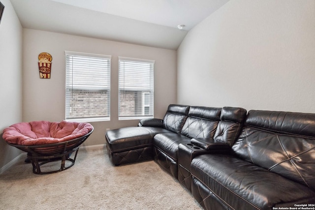 carpeted living room featuring vaulted ceiling