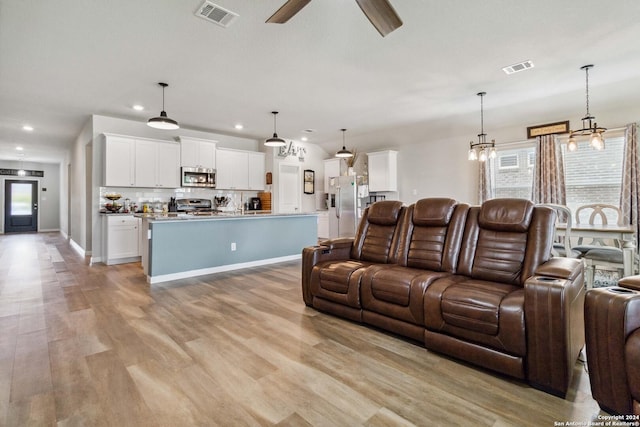 living room with ceiling fan and light wood-type flooring