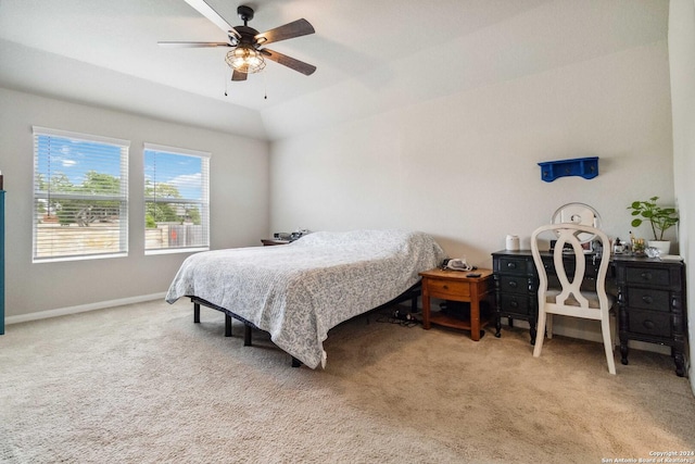 bedroom featuring light carpet, vaulted ceiling, and ceiling fan