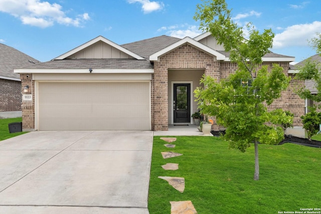 view of front of house with a garage and a front yard