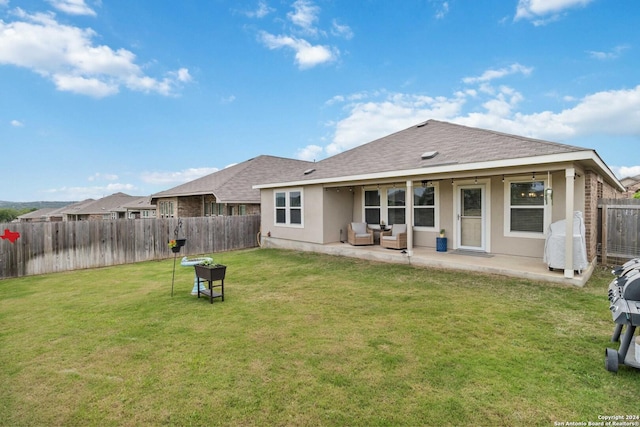 back of house featuring a yard and a patio