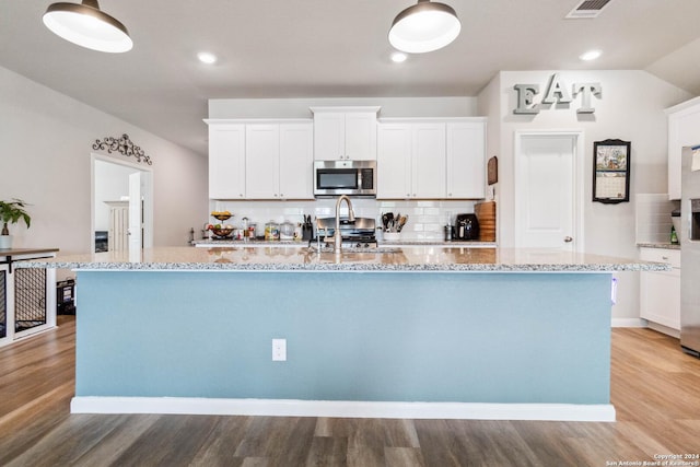 kitchen featuring a center island with sink, white cabinets, and appliances with stainless steel finishes