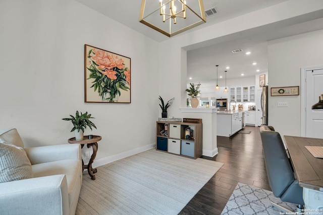 living room featuring sink, hardwood / wood-style floors, and a chandelier