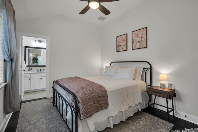 bedroom with lofted ceiling, sink, ceiling fan, ensuite bathroom, and dark hardwood / wood-style flooring