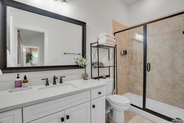 bathroom featuring vanity, an enclosed shower, and toilet