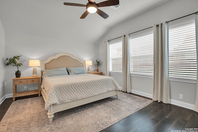 bedroom with ceiling fan, lofted ceiling, and dark hardwood / wood-style floors