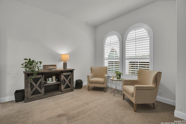 living area featuring lofted ceiling and carpet floors