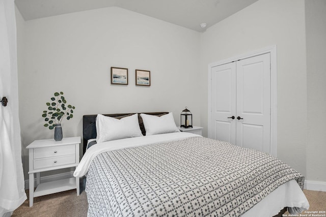 bedroom featuring vaulted ceiling, carpet, and a closet