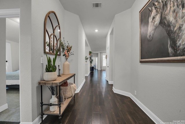 hallway with dark hardwood / wood-style flooring