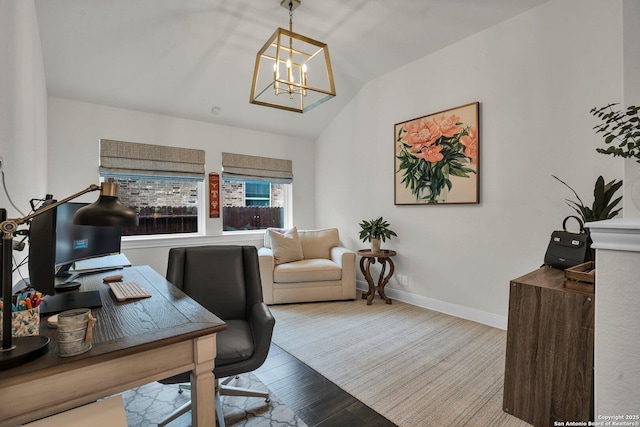 home office featuring lofted ceiling, wood-type flooring, and an inviting chandelier