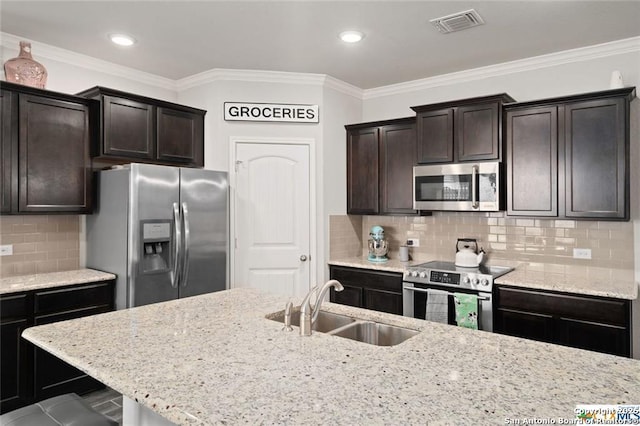 kitchen with crown molding, appliances with stainless steel finishes, sink, and dark brown cabinets