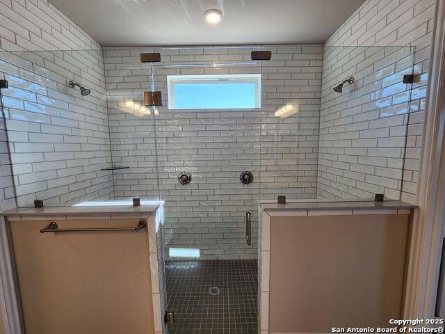 bathroom featuring a shower with door