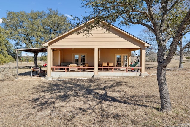 rear view of property featuring french doors