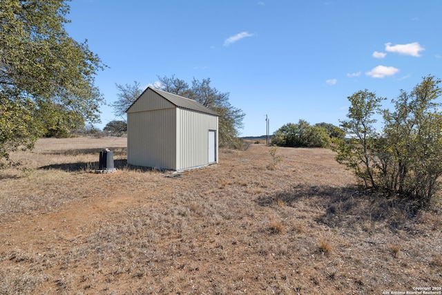 view of outbuilding with a rural view