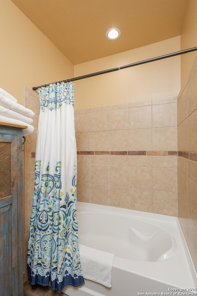 bathroom with shower / bathtub combination with curtain