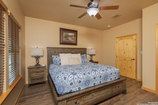 bedroom with ceiling fan and dark hardwood / wood-style flooring