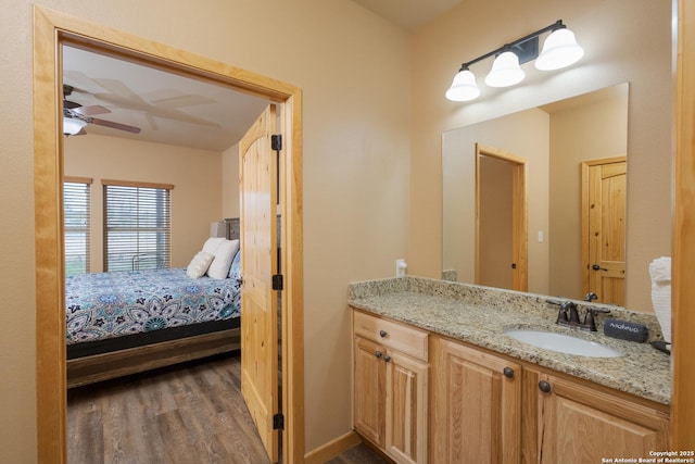 bathroom with ceiling fan, vanity, and hardwood / wood-style floors