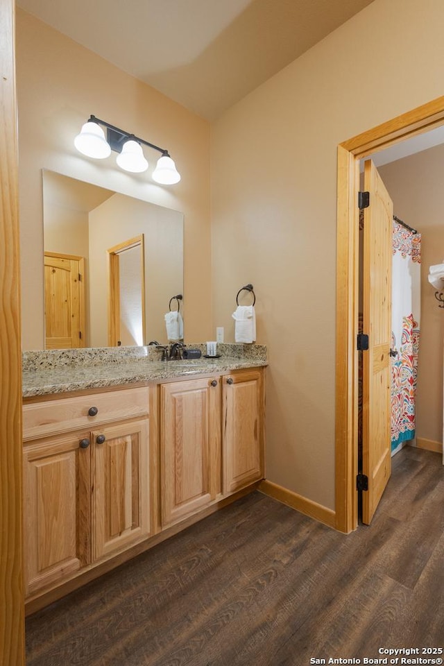 bathroom with vanity and hardwood / wood-style floors