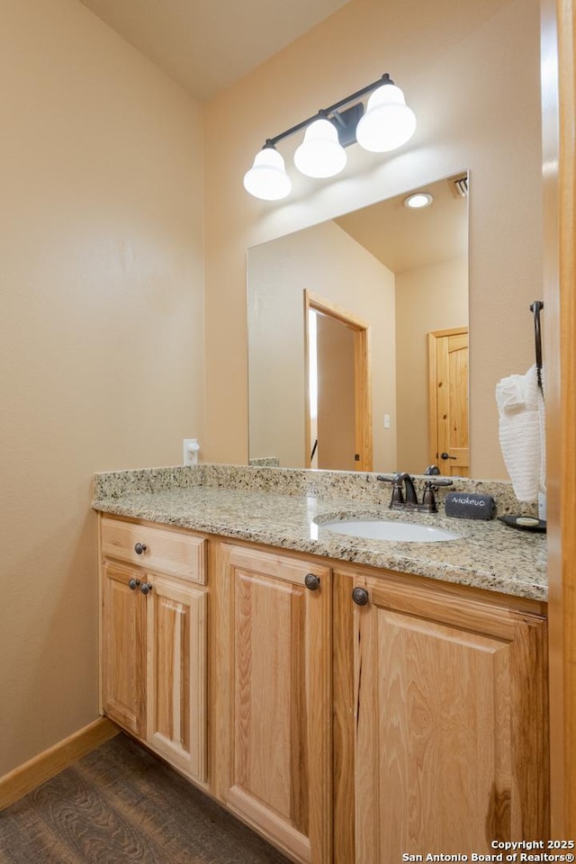 bathroom with hardwood / wood-style flooring and vanity