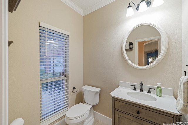 bathroom featuring ornamental molding, vanity, and toilet