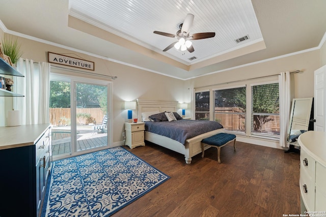 bedroom featuring ornamental molding, dark wood-type flooring, access to outside, and a tray ceiling