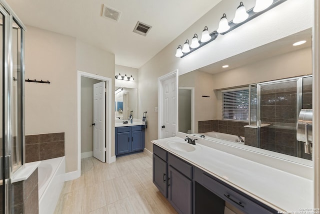 bathroom featuring vanity and separate shower and tub