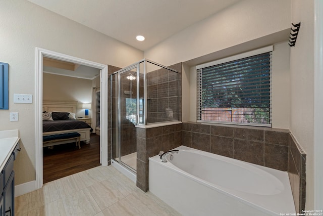 bathroom featuring vanity and independent shower and bath