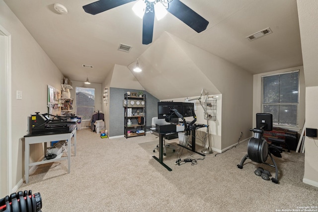 exercise room featuring lofted ceiling and light carpet