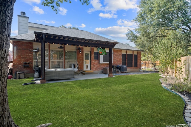 back of house with a yard, an outdoor hangout area, a patio, and ceiling fan