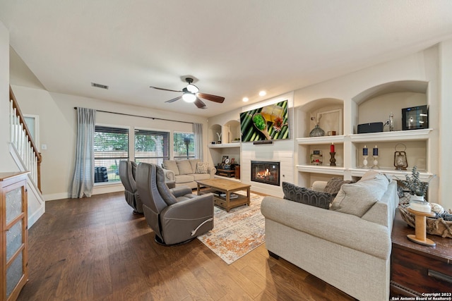 living room with ceiling fan and dark hardwood / wood-style floors