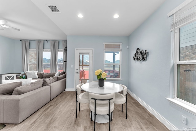 dining space with light hardwood / wood-style floors and ceiling fan