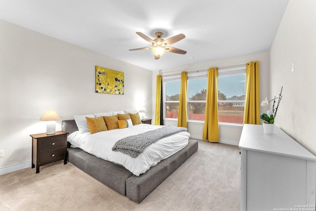 bedroom with light colored carpet and ceiling fan